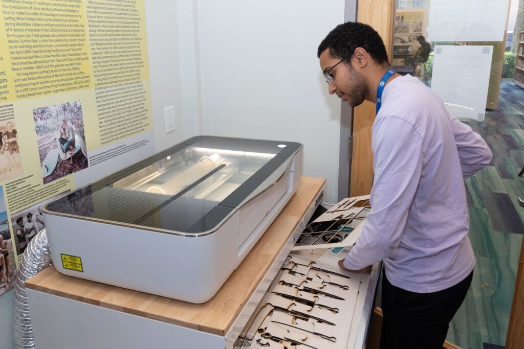 Teen Using a Glowforge Laser Cutter